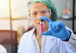 © sutlafk - Asian female Laboratory scientist working at lab with test tubes. Discovering cure. Concentrated young woman scientist holding test tube and looking at it while sitting at her working place.