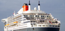 Rear View Of Stern And Superstructure With Red Funnel Of Legendary Ocean Liner Or Cruiseship Or Cruise Ship Liner QM2 Or Queen Mary 2