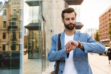 Wall Mural - Young attractive man looking at his watch