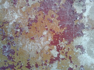 old wall texture with peeled red paint