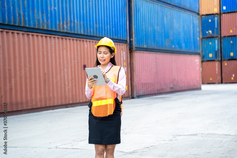 Shipping Container Job Container worker women in cargo shipping workplace working and checking ...