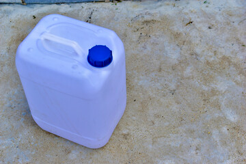 White plastic canister with blue lid in different positions