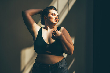 Beautiful plus size woman relaxing in underwear.