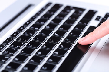 Poster - Female hand typing on laptop keyboard
