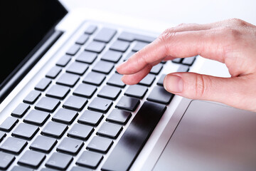 Poster - Female hand typing on laptop keyboard
