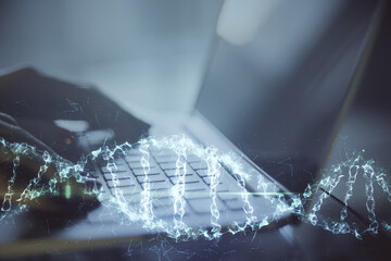 Aufkleber - Close up of hand typing on keyboard laptop with digital dna spiral hologram.
