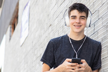 Sticker - young man on the street with mobile phone and headphones