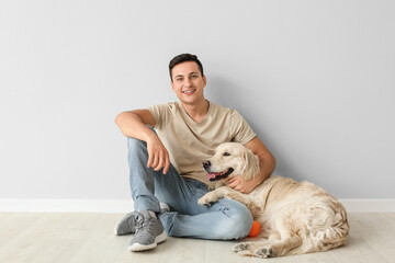 Young man with cute dog indoors