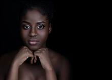 Close Up Of Beautiful Young Black Woman With Beautiful Skin And Makeup Looking At Camera