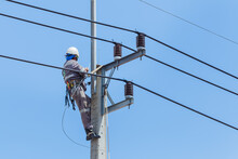 Electricians Wiring Cable Repair Services,worker In Crane Truck Bucket Fixes High Voltage Power Transmission Line,setting Up The Power Line Wire On Electric Power Pole.