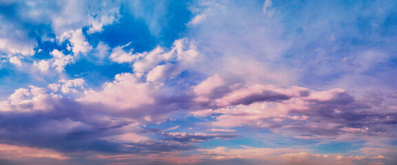 Bright sunlight shining through the clouds against the backdrop of a breathtaking evening sky at sunset. panorama, natural composition