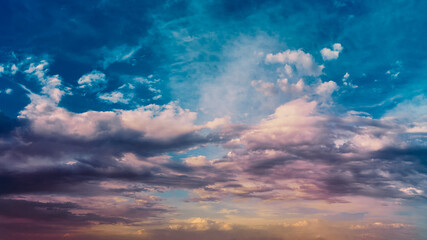 Wall Mural - bright sunlight shining through the clouds against the backdrop of a breathtaking evening sky at sun