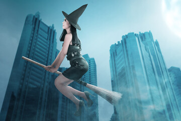 Wall Mural - Asian witch woman with hat flying on a magic broomstick