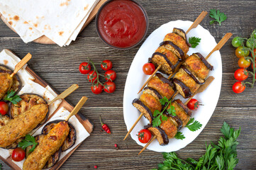 Wall Mural - Griled meatballs with eggplant on skewers. Chicken kebab with vegetables and lavash. Diet meat dish. The top view