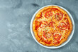 © ismishko - Classic italian pizza margarita with tomatoes and cheese in a white plate on a concrete background