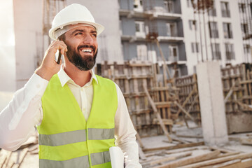 Positive construction inspector talking on phone