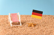 Sunbed on the beach with German flag. Vacation in Germany.