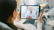 © Gorodenkoff - Girl Sick at Home Using Digital Tablet to Talk to Her Doctor via Video Conference Medical App. Woman Has Conversation with Professional Physician Using Online Video Chat Application. Close-up POV View