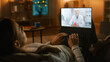 © Gorodenkoff - Girl Sick at Home Using Laptop Computer to Talk to Her Doctor via Video Conference Medical App. Beautiful Woman Has Conversation with Professional Physician, Using Online Video Chat App. Late at Night
