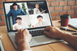 © joyfotoliakid - Asian man working from home use Smart working and video conference online meeting with Asian team using laptop and tablet online in video call for new projects