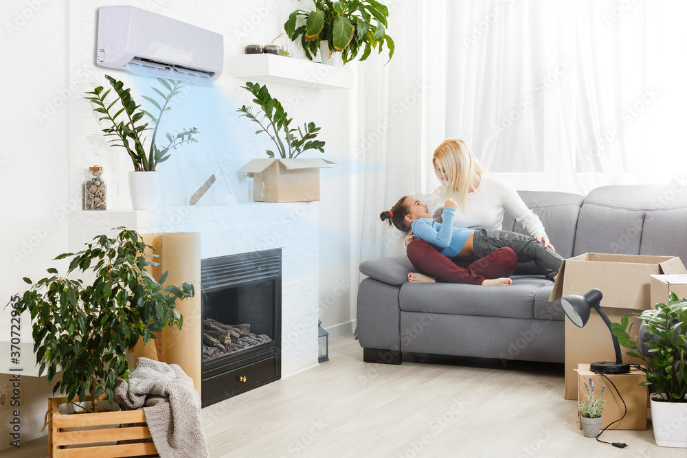 air conditioning in living room with happy family moving to new apartment - obrazy, fototapety, plakaty 