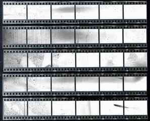 5 long and empty or blank 35mm filmstrips, black and white film material behind real foil, cool retro photo placeholder, contact film sheet.