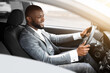 © Prostock-studio - Cheerful african american businessman driving to work
