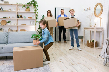 Wall Mural - Family Packing Boxes Moving To New Apartment Standing Indoors