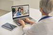 © Studio Romantic - Mature pediatrician giving online consultation to mother and son from clinic. Female doctor speaking with clients on web