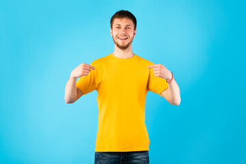 Wall Mural - Happy young man pointing fingers at himself