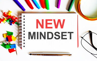 Poster - white text NEW MINDSET on the notepad , multi-colored felt-tip pens