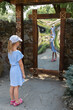 little girl in front of distorting mirror. funhouse mirror in a park