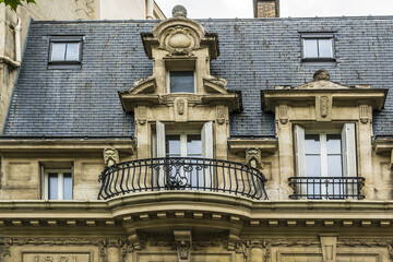 Old French house with traditional balconies and windows. Paris, France.