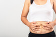 © sorapop - Close up of Asian mother woman showing stretch mark loose lower abdomen skin she fat after pregnancy baby birth, studio isolated on white background, Healthy belly overweight excess body concept