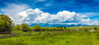 Montana Big Sky Landscape of a ranch fence with clouds and mountains in the background