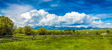 Montana Big Sky Landscape Of A Ranch Fence With Clouds And Mountains In The Background