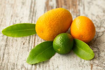 Wall Mural - Top view of bunch of fresh kumquats in the organic food market. Some kumquats is cutted.