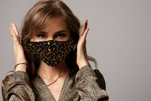 Woman Wearing Stylish Protective Black Velvet Face Mask With Golden Rhinestones, Beads. Fashion Accessory During Quarantine Of Coronavirus. Close Up Studio Portrait. Copy, Empty Space For Text