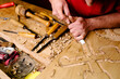 © Alberto Menendez/ADDICTIVE STOCK - Unrecognizable crop male wood carver using metal chisel while creating ornaments on plank working in workshop