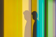 © Javier Bravo/ADDICTIVE STOCK - Side view of shadow of young male with curly hair standing in studio with neon lights