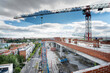 © Kavi Sanchez/ADDICTIVE STOCK - Majestic view of spacious construction site with tall crane surrounded by brick buildings