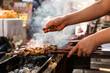 © Luis Gomez/ADDICTIVE STOCK - Side view of anonymous man seasoning meat on skewers while cooking delicious kebab in kitchen