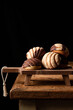 © Pimienta Dulce/ADDICTIVE STOCK - Freshly baked traditional concha bread placed on wooden cutting board on black background