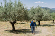 © Victor Gonzalez/ADDICTIVE STOCK - Male worker in protective helmet and uniform mowing grass with brush cutter on sunny day on background of amazing landscape