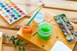 © Westend61 - Watercolor paints with water and paintbrushes on wooden table home