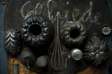 Collection Of Old Rustic Cooking Utensils Including Baking Pans, Baking Sheet, Grater, Wire Whisk And Funnel