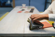 © Westend61 - Hand of architect, choosing from cloth samples