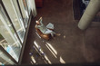 © Westend61 - Senior man relaxing on a chair in a loft flat