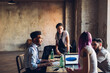 © Westend61 - Creative business people working at table in loft office