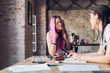 © Westend61 - Two creative businesswomen talking in loft office